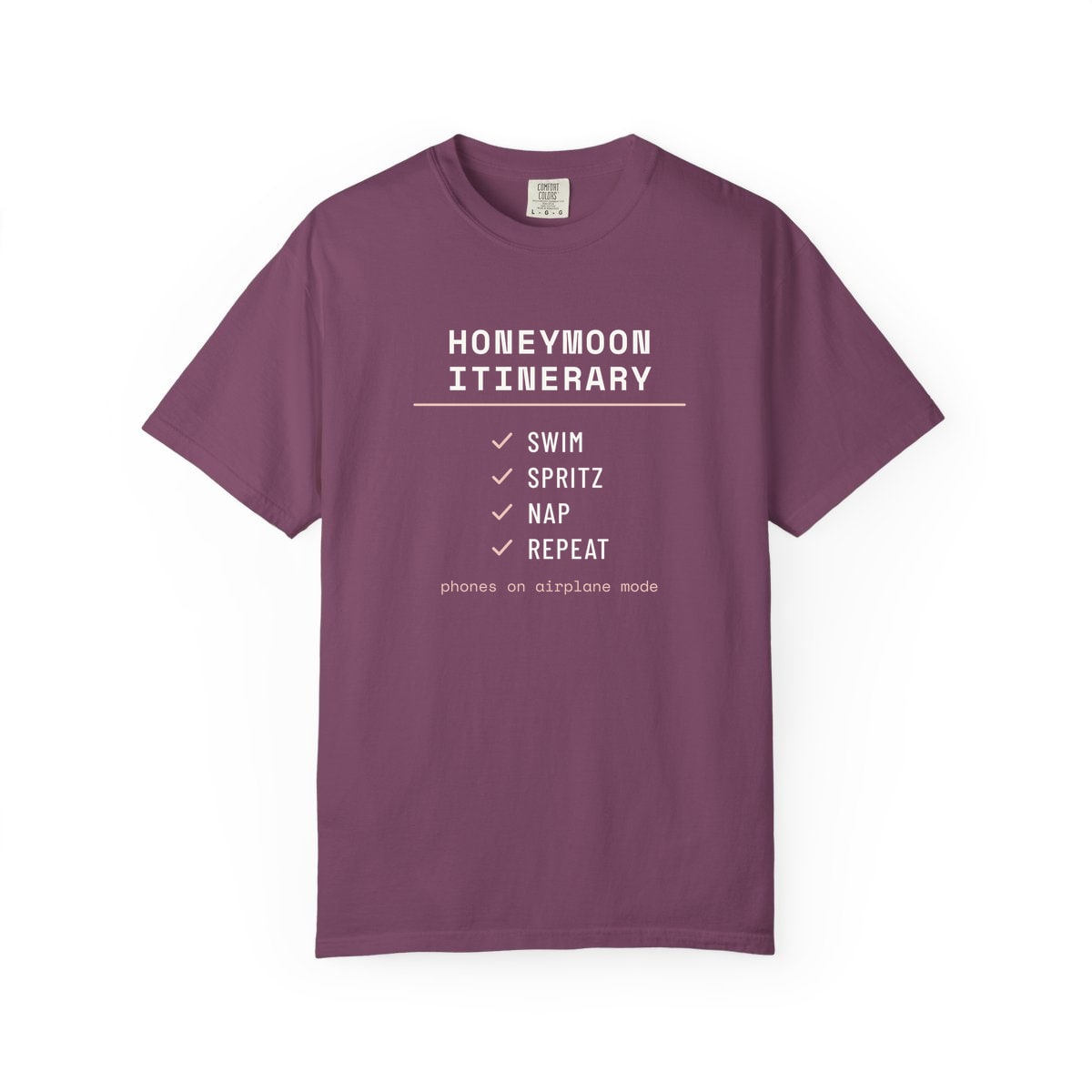 The Honeymoon Itinerary, printed on a Comfort Colors garment-dyed t-shirt in Berry