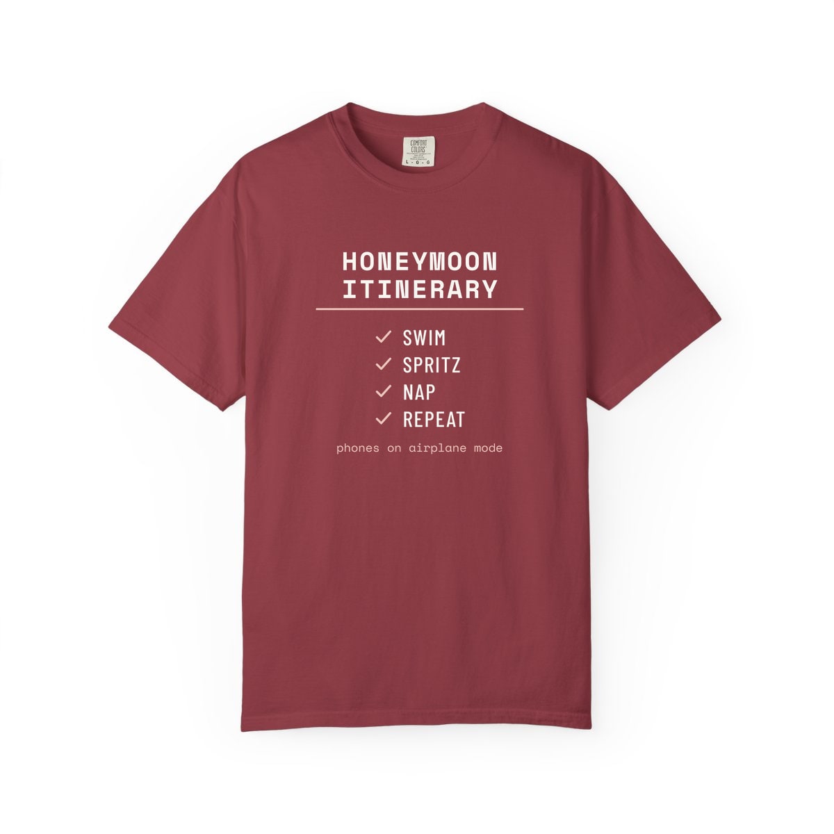 The Honeymoon Itinerary, printed on a Comfort Colors garment-dyed t-shirt in Chili