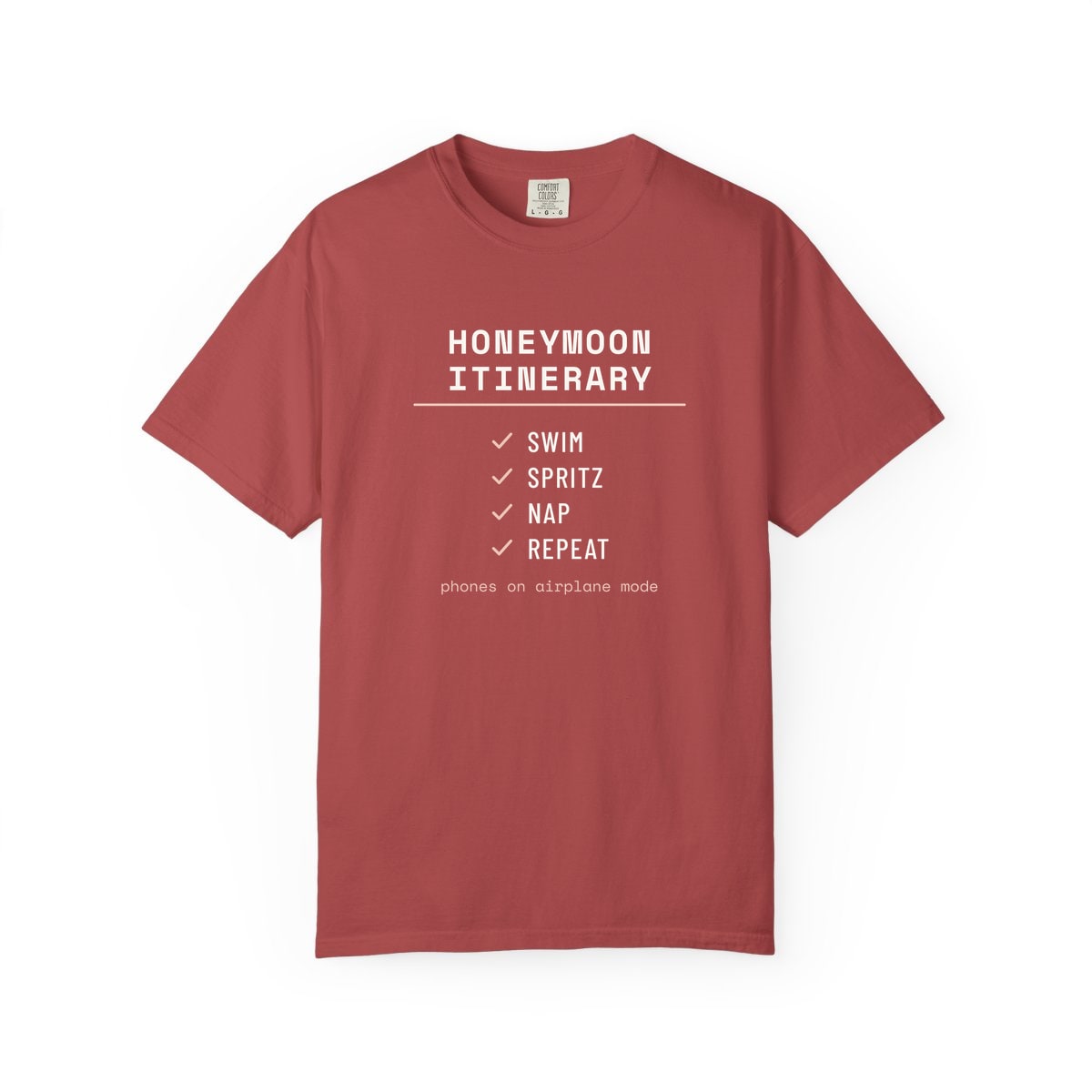 The Honeymoon Itinerary, printed on a Comfort Colors garment-dyed t-shirt in Crimson