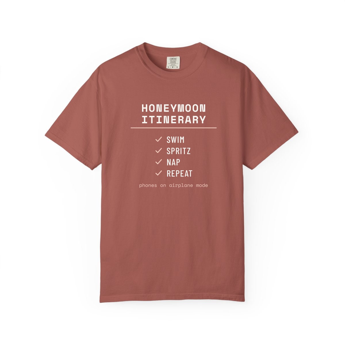 The Honeymoon Itinerary, printed on a Comfort Colors garment-dyed t-shirt in Cumin